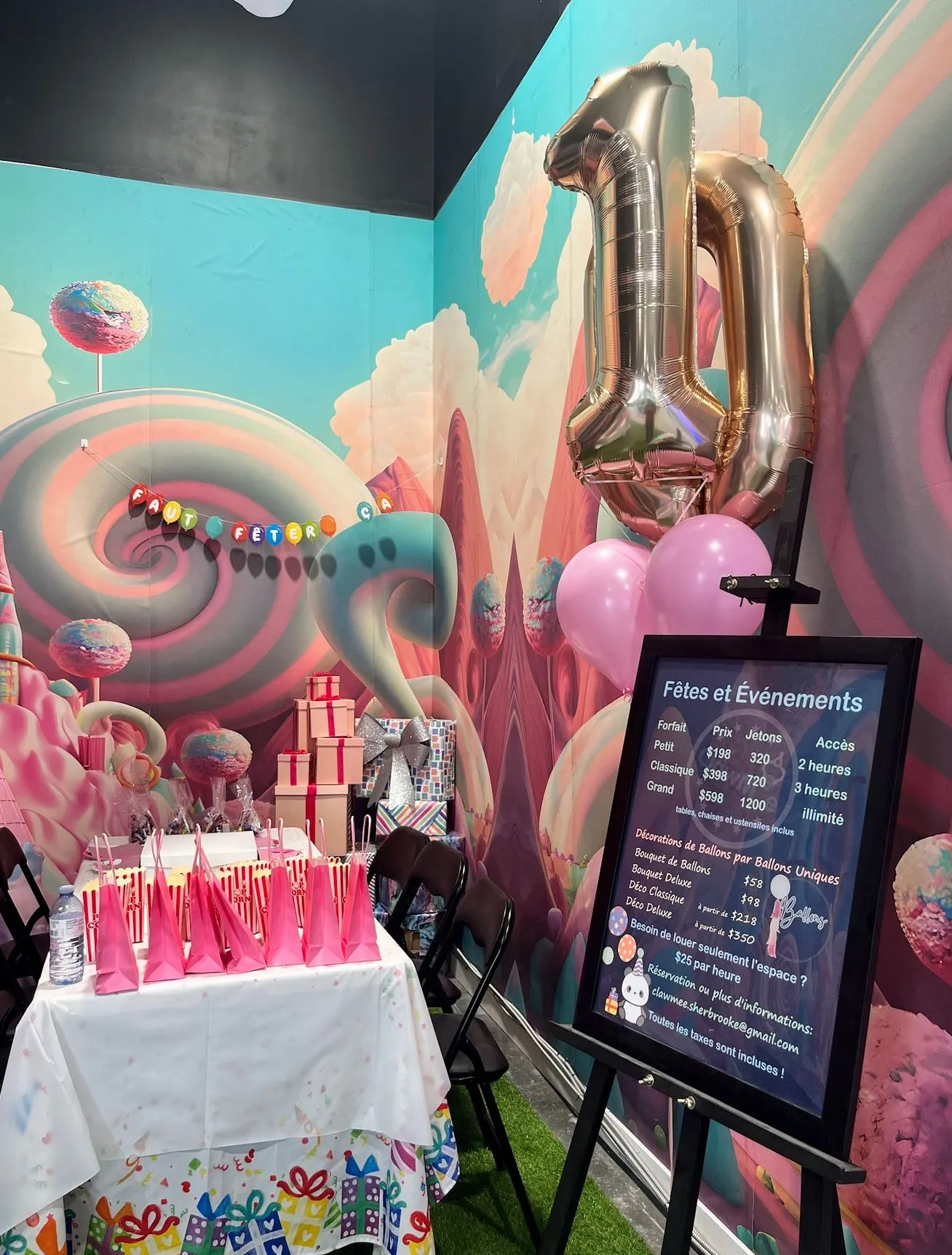 Candyland party corner with a giant number balloon, treat bags and gifts